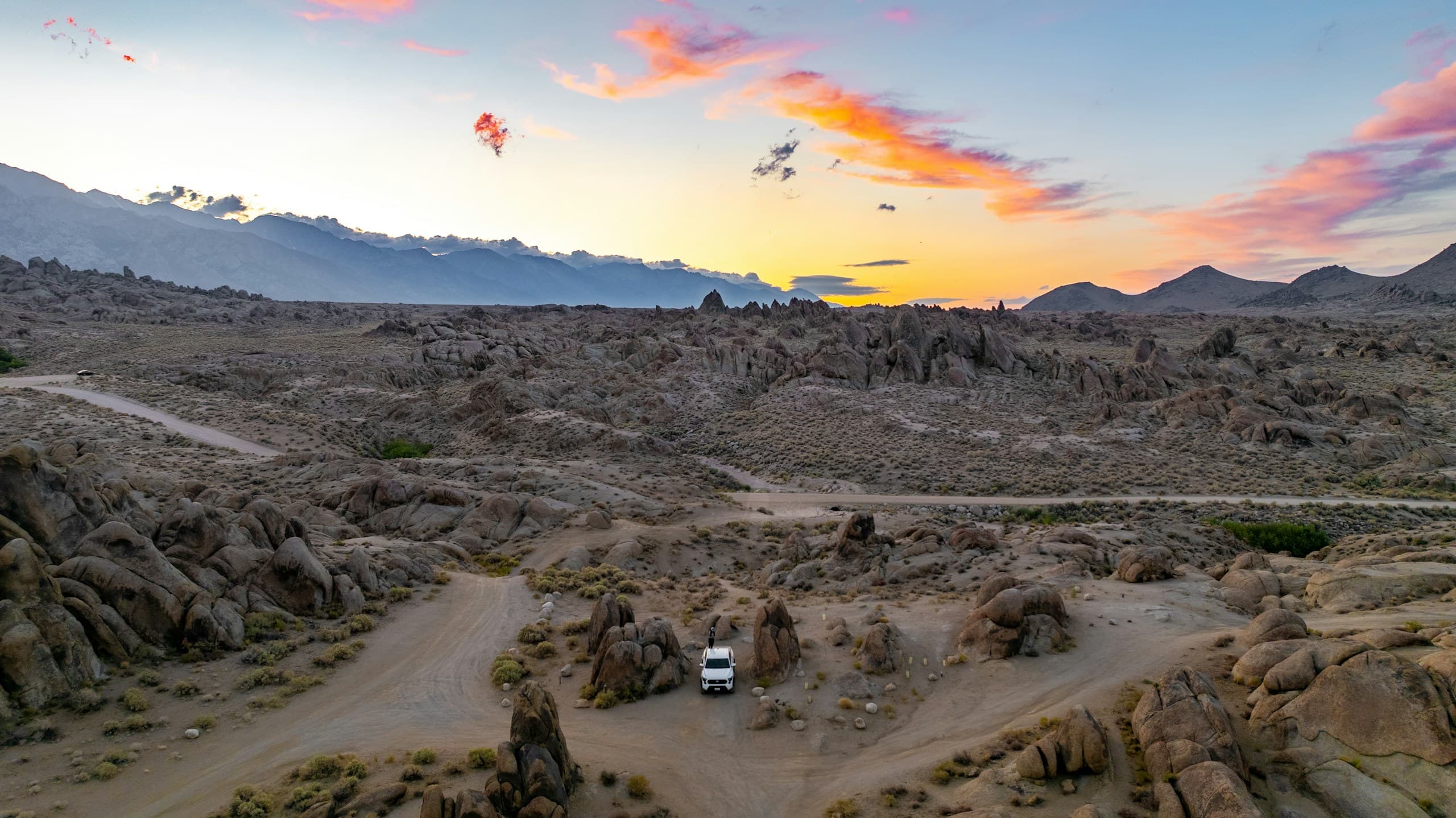 RV camping in a rocky desert landscape at sunset